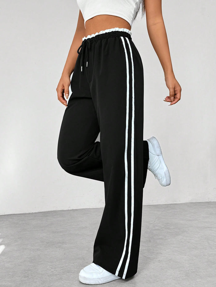 Women's straight pants with side stripes and elastic waistband