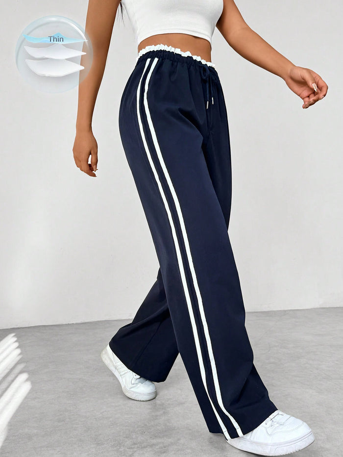 Women's straight pants with side stripes and elastic waistband