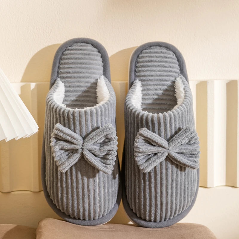 Warm women's closed slippers with bow detail for comfort and style