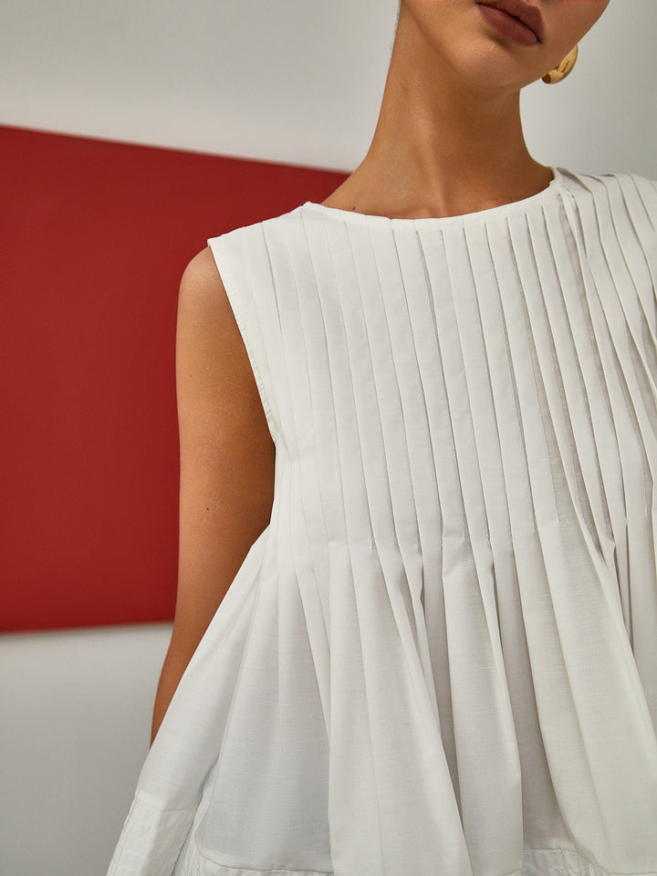 Sleeveless Pleated Peplum Blouse – Elegant Waist-Emphasized Look