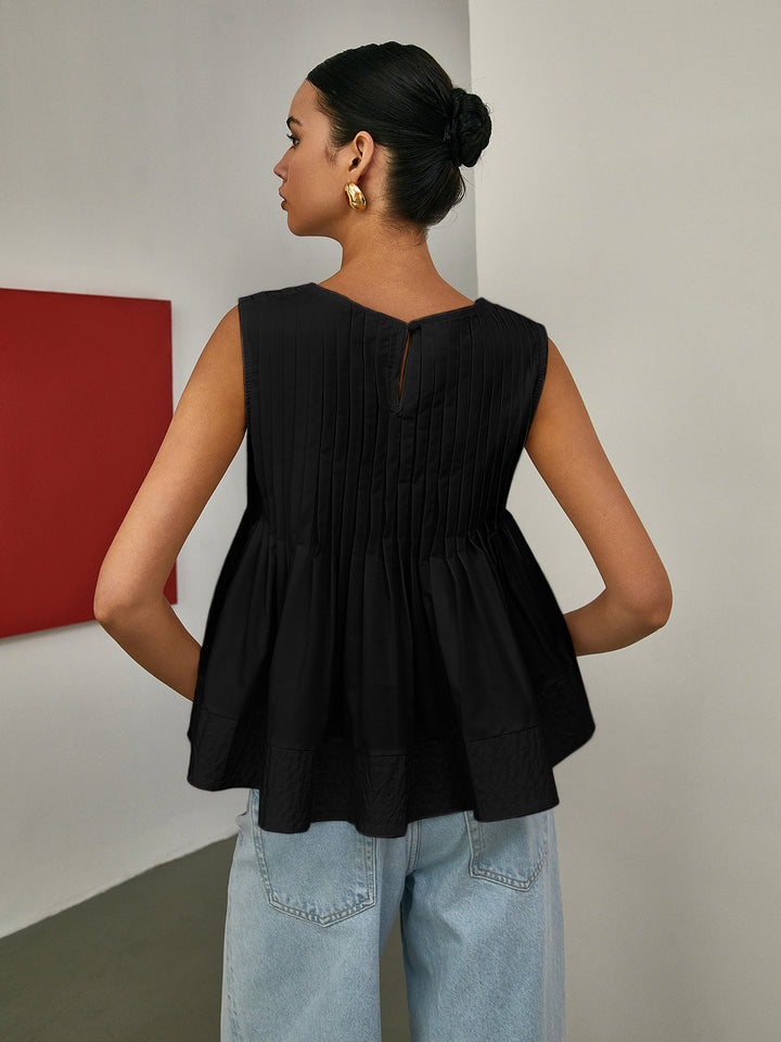 Sleeveless Pleated Peplum Blouse – Elegant Waist-Emphasized Look
