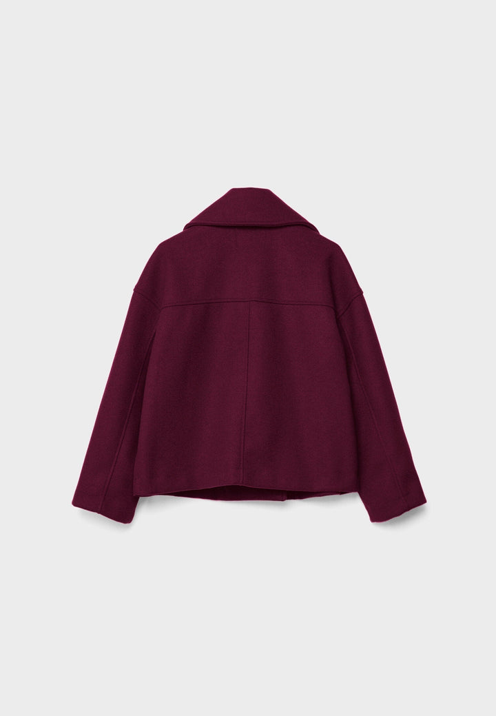 Short women's coat with double row of buttons made of vegan leather