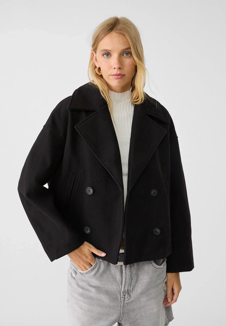 Short women's coat with double row of buttons made of vegan leather