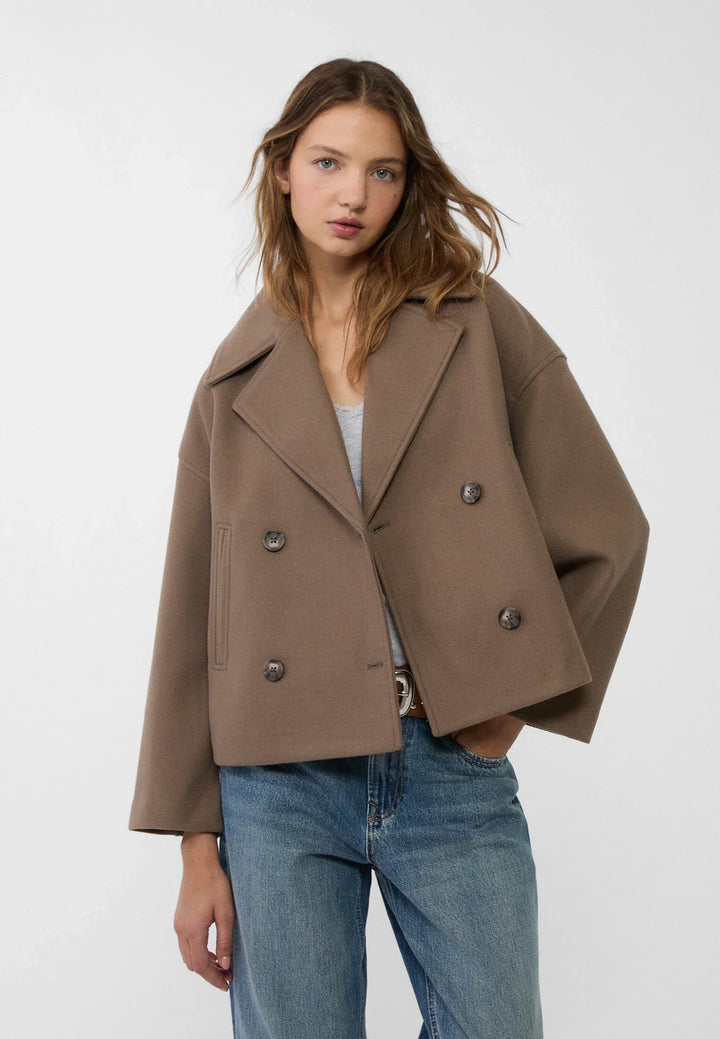 Short women's coat with double row of buttons made of vegan leather