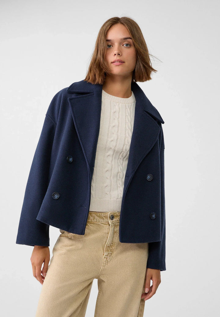 Short women's coat with double row of buttons made of vegan leather