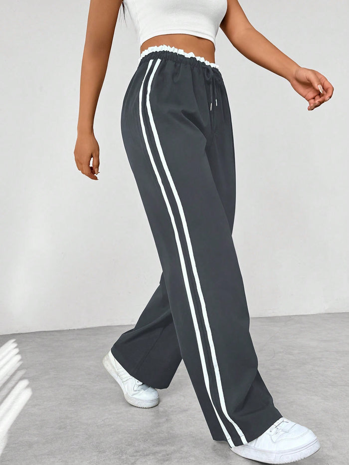 Women's straight pants with side stripes and elastic waistband